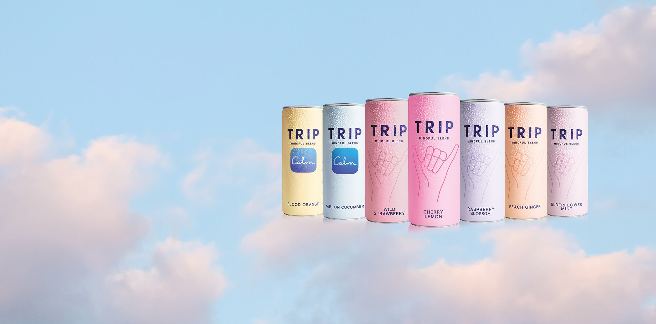 Set of 'TRIP' magnesium drink cans against a blue sky with clouds